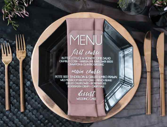 Set the Table with Acrylic Dinner Menus Acrylic can be used in just for just about all wedding stationery and signage. Take the traditional place setting to the next level with a clear menu set upon tasteful dinner plate.